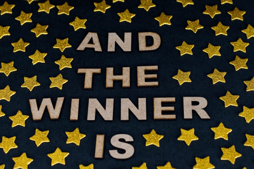 Flat lay photography with the phrase "And the winner is"